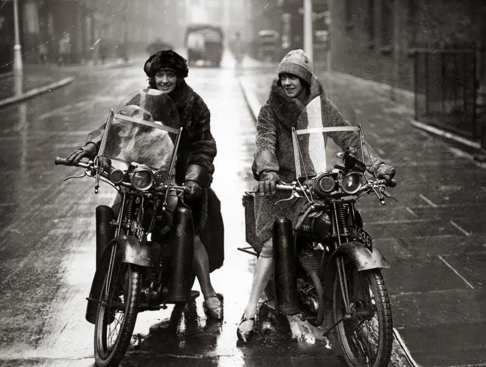 Nancy and betty debenham, well-known motorcyclists, riding bsa bikes with their dog, 1925.