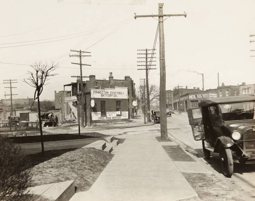 Cars parked along the street at 3127 Gravois, near its intersection with Juniata. The Princeton Electric Battery Co. can be seen at 3115 Gravois, and the Kranz Automotive Body Co. was located at 3034 Gravois, 1930