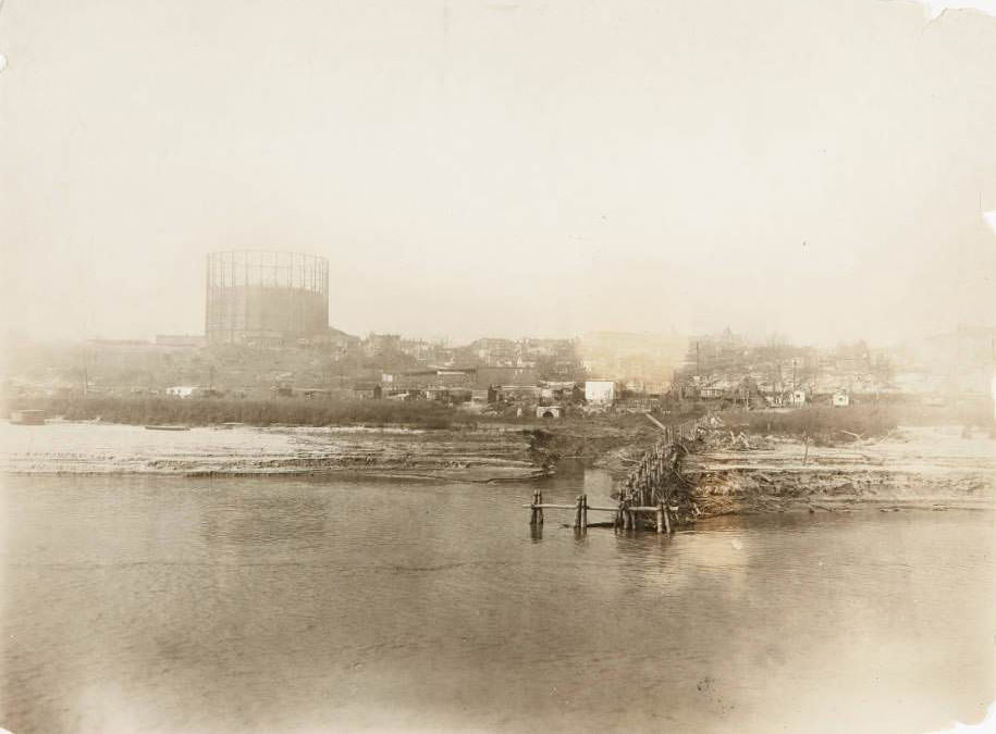 Mississippi riverfront at Gasconade Street, in what would become the Marine Villa neighborhood, with a gasometer on a hill in the distance, 1930