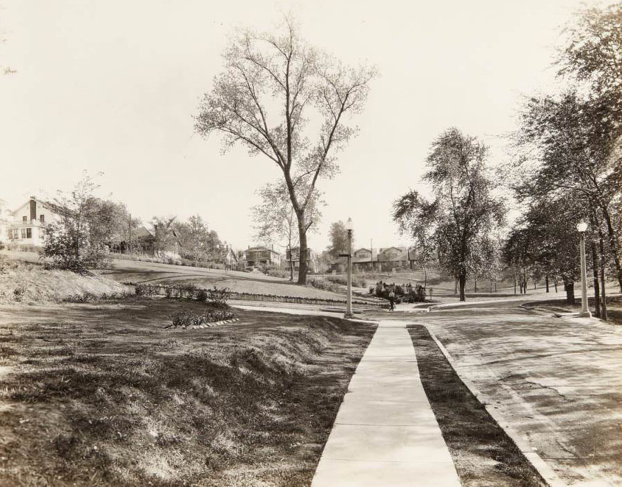 Boy in rollerskates standing in a new addition to the Clifton Heights neighborhood, 1930