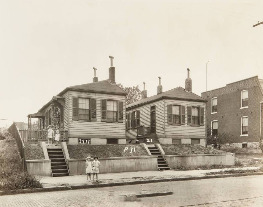 Group of children standing in front of homes at 3919 and 3921 North Florissant Avenue, 1930