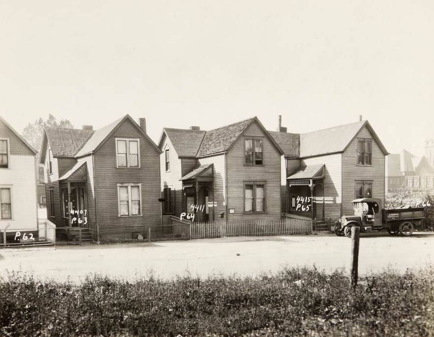 Wood-sided homes on the 4400 block of N. Florissant Ave. at 4407, 4411, and 4415. J. Martin's truck is parked in front of 4415, 1930