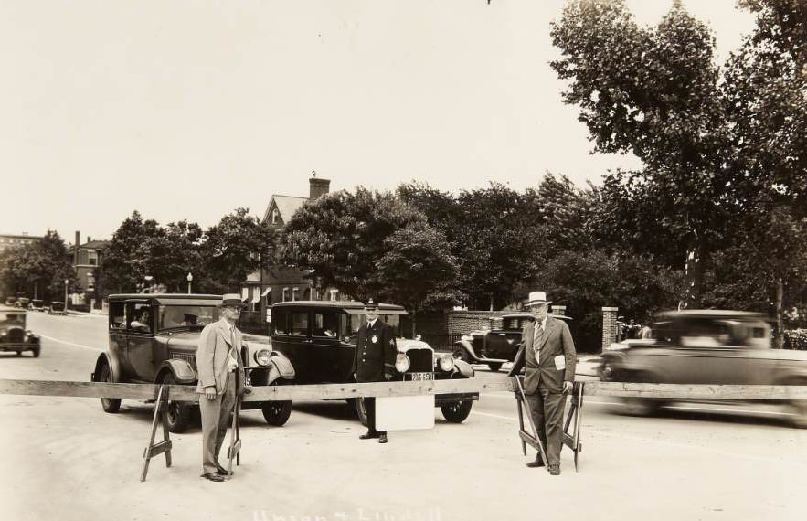 Union and Lindell boulevards, 1931 - A police officer and two other men standing next to a wooden traffic barricade at the intersection of Lindell and Union boulevards.