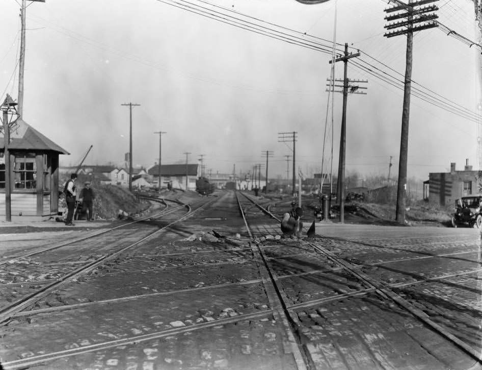 View of streetcar tracks and street repair. Locations unknown, 1930