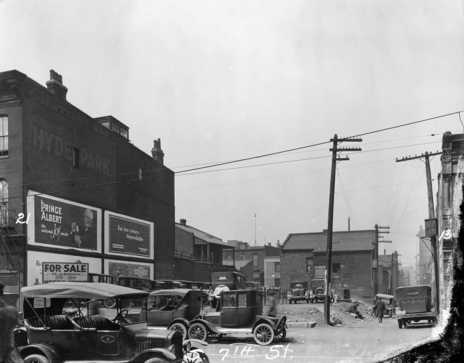 View down alley between #21 and #13 South 7th St. with empty lot and William Goertzen's Bar visible, 1930