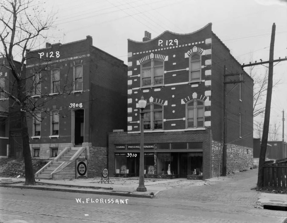 View of two buildings on the 3900 block of West Florissant which housed a laundry and hat shop respectively, 1930
