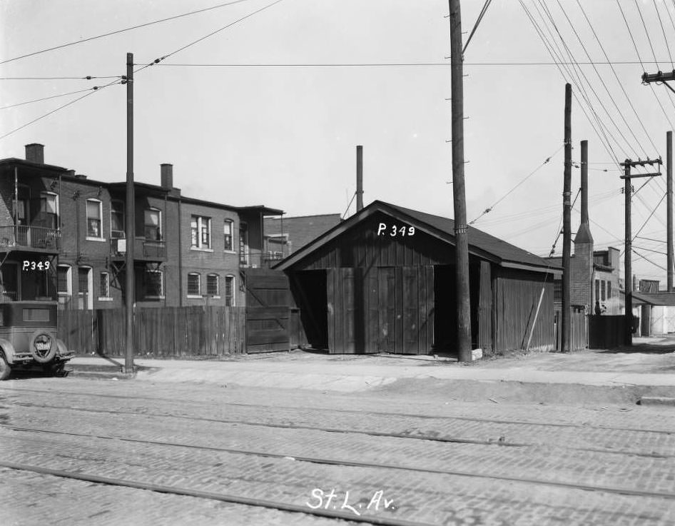 View of a garage and rears of multi-family residences, 1930