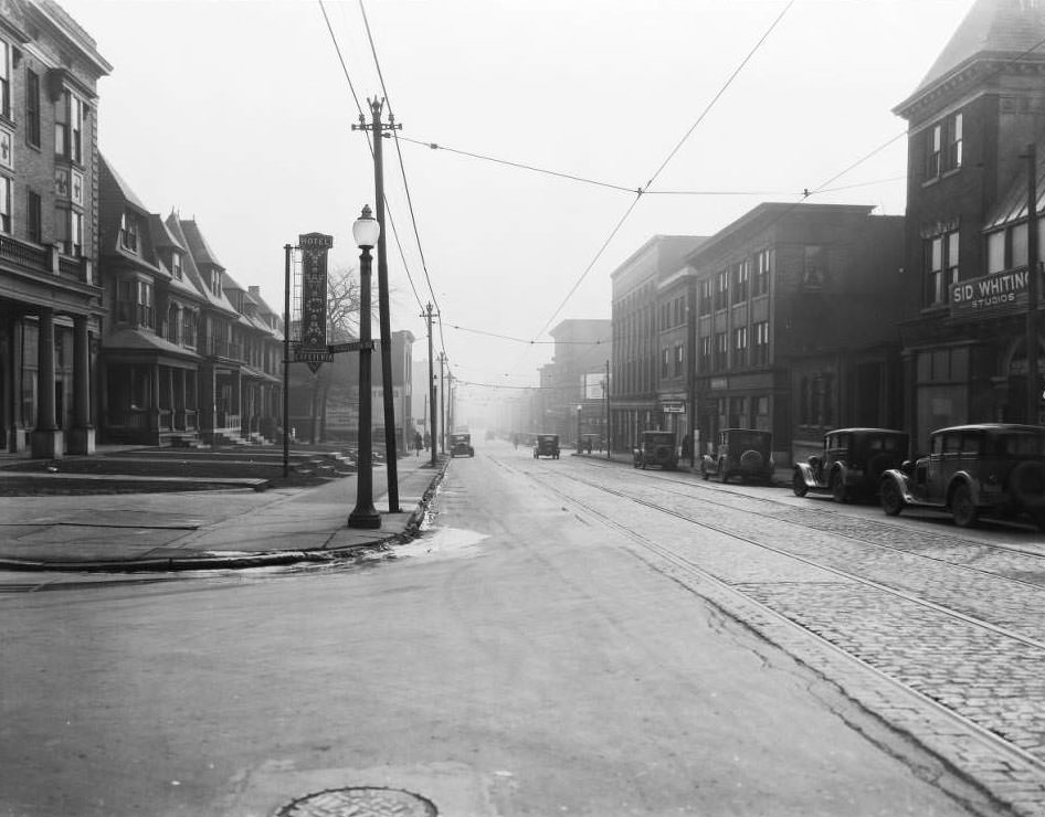 View east down Olive Street at the intersection with Pendleton Ave. Y.W.C.A. Hotel and Cafeteria and Sid Whiting Studios are visible, 1930