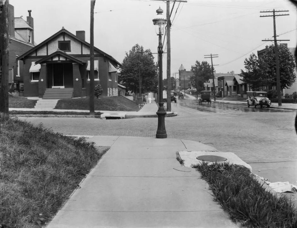 View looking east down Osceola at South Compton in the Dutchtown neighborhood with a woman and child walking away from the camera, 1930