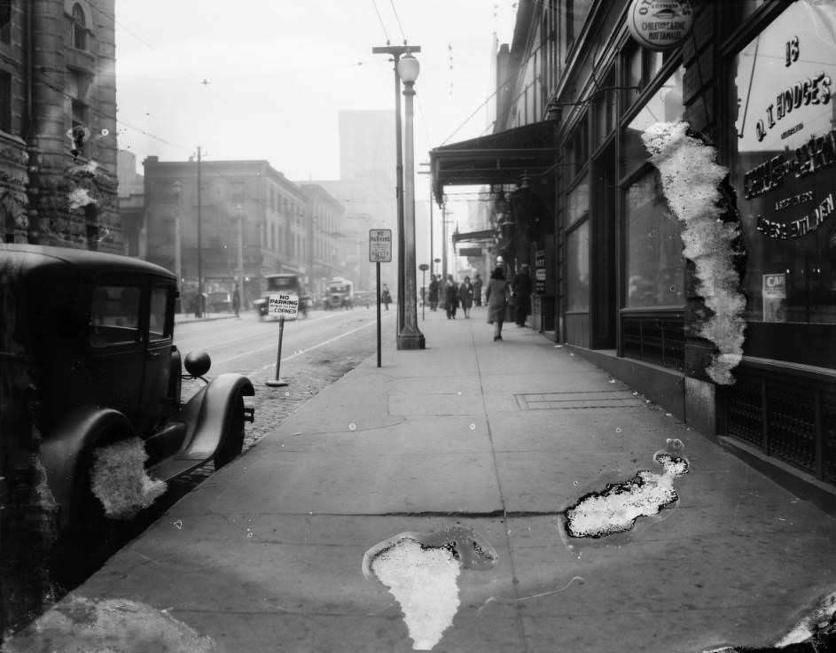 Downtown sidewalk view including O. T. Hodges Chile Con Carne and Hot Tamale Restaurant at 18 South 18th Street, 1930