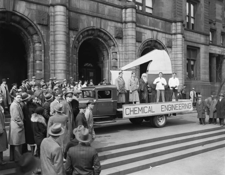 A truck and five men decorated for a parade with a Chemical Engineering sign parked in front of St. Louis City Hall, 1930