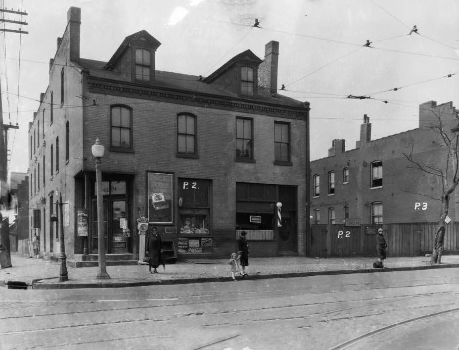 View of commercial building at Kossuth and North Grand near Fairgrounds Park, with shoeshine parlor, confectionery, and C.J. Gast Barbershop, 1931
