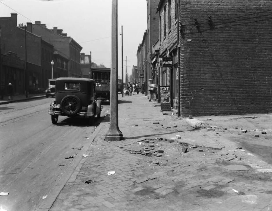View of sidewalk in front of an empty lot between 1505 and 1509 Biddle, with John Noffsinger's restaurant at 1509 Biddle visible, 1931
