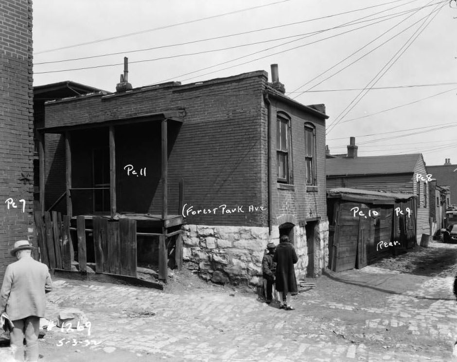View of three people in an alley off of Forest Park Avenue, 1932