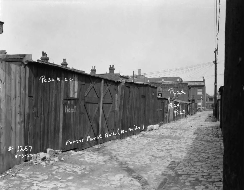 View of sheds and garages on Forest Park Ave. alley, north side, with "Keep Out" written on one door, 1932.