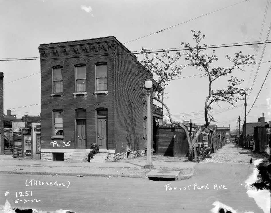 View of man sitting on front steps of a building on Forest Park Ave., 1932.