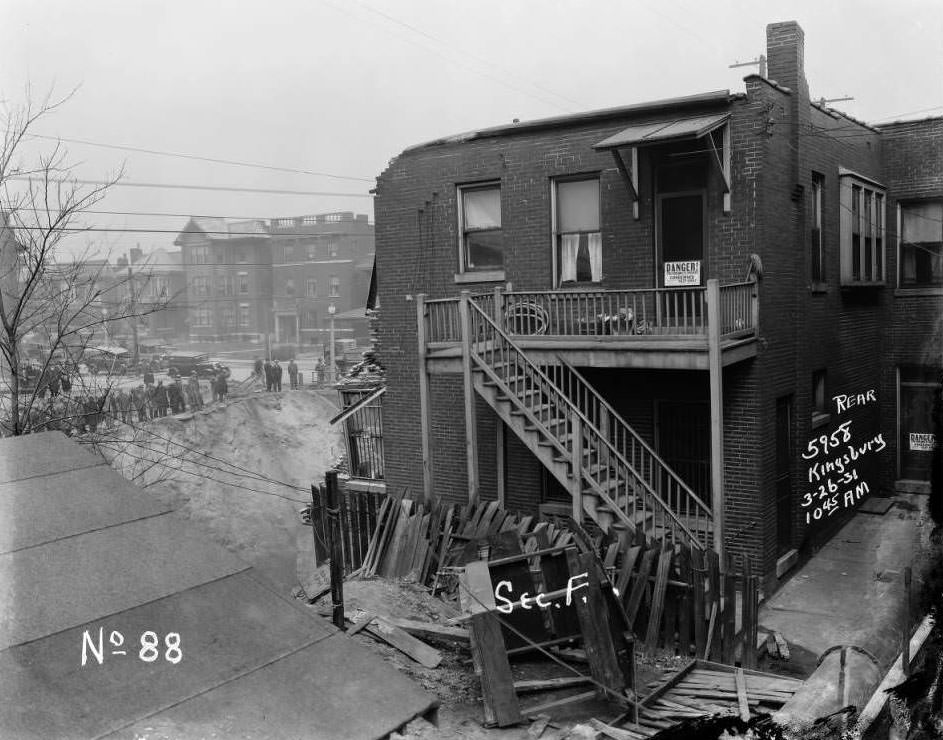 Kingsbury Pharmacy at 5958 Kingsbury in University City after collapse, with a row of onlookers watching from below, 1931