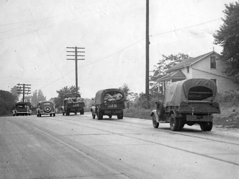 Army trucks prepare and march, 1930.