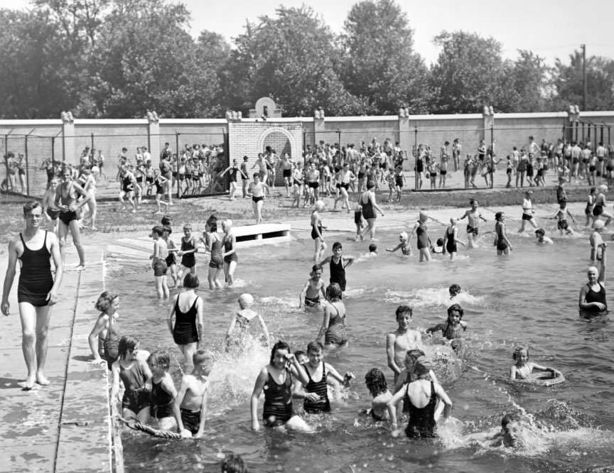 Fairgrounds Swimming Pool gate opens to a swarm of children who had been waiting in the sun for hours, 1930