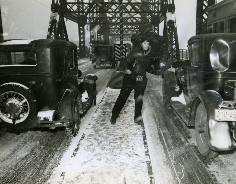 Louis Lasser, 34-year-old MacArthur Bridge attendant, insists he has "easily the coldest job in St. Louis" despite his heavy clothing, 1930