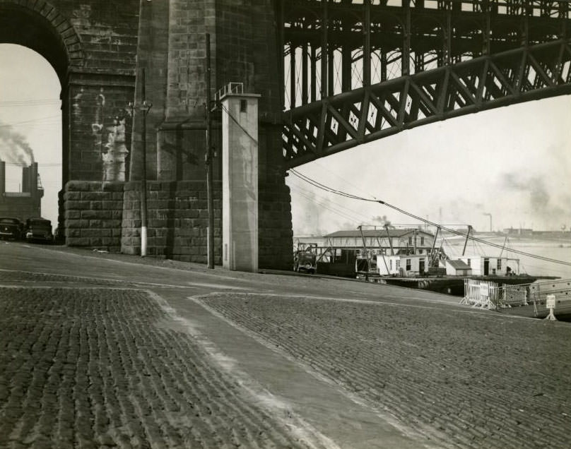 The tower against the bridge pier in the Mississippi River is the Weather Bureau's automatic river stage gauge at the Eads Bridge, 1930