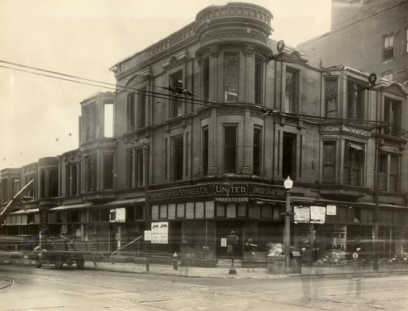 Three-story building at the southeast corner of Grand Boulevard and Olive Street being torn down to make way for a new two or three-story structure, 1930