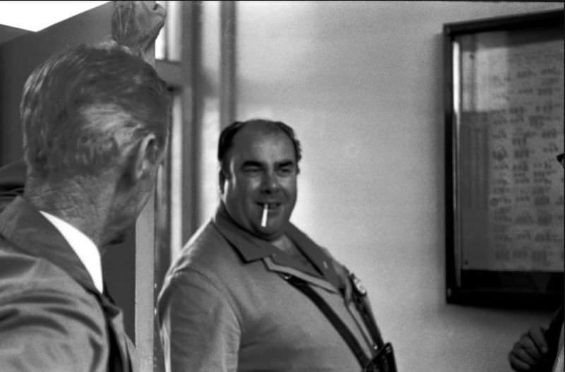 Conductor Trev enters the staff rest room in Paignton bus station, 1970