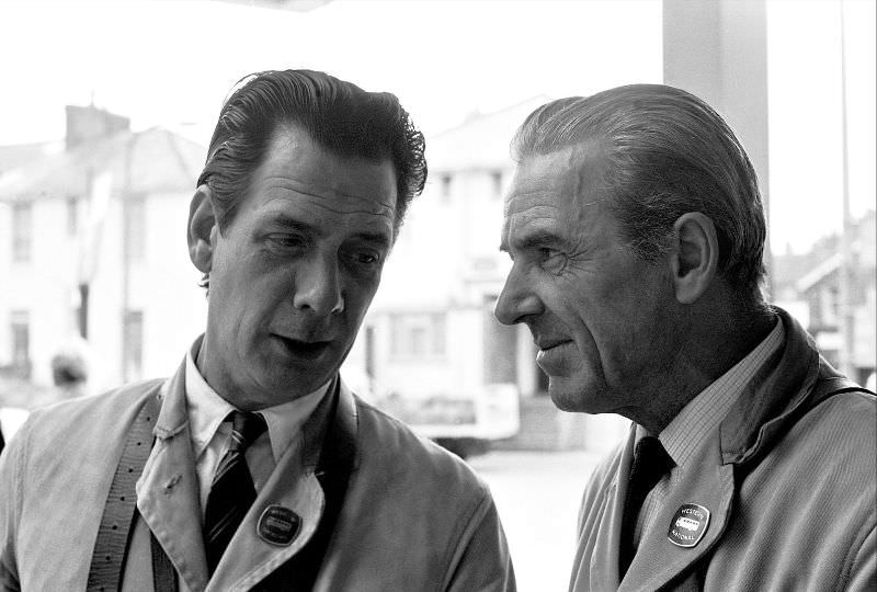 Conductors catch up on the gossip between trips, Paignton bus station, 1970