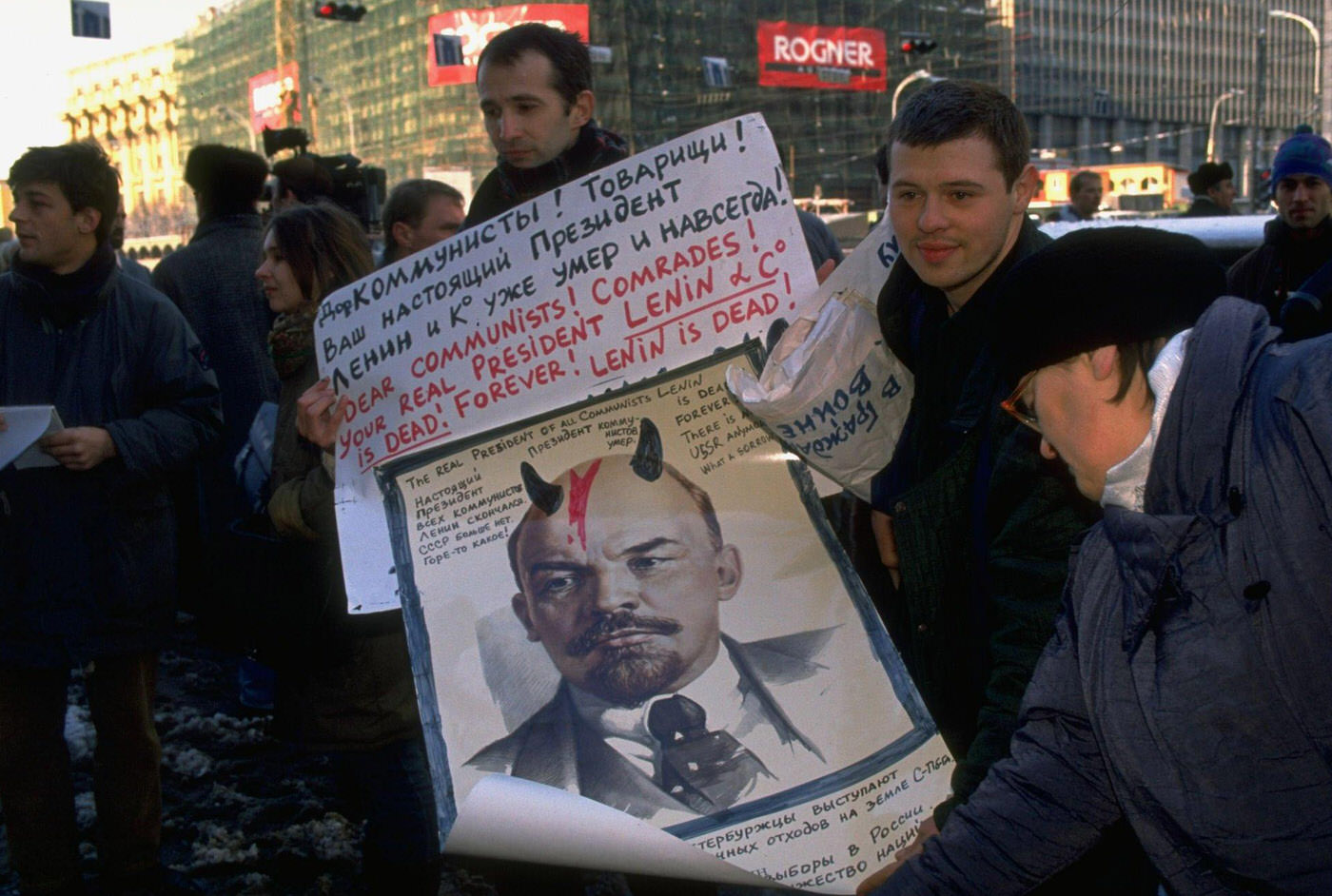 Counter-demonstrators with Russian-English sign portraying Lenin as a horned devil during pro-communist demonstration.