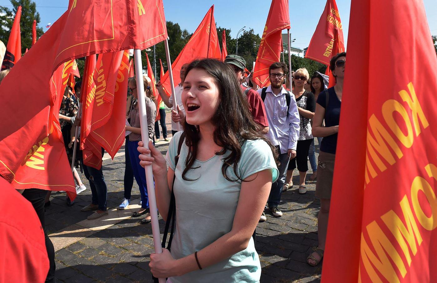 Russian Communist supporter holds red flag and shouts slogans during rally in downtown Moscow marking the 25th anniversary of the August 1991 putsch.