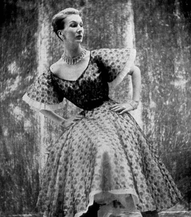 Barbara Goalen in black lace over pleated pink tulle dress by Susan Small, 1951.