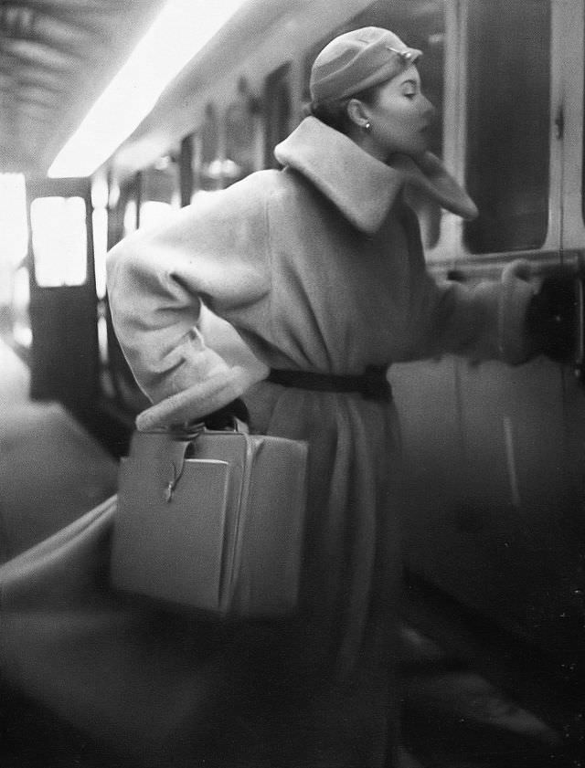 Barbara Goalen in long-haired fleecy coat in alpaca and wool at Marcel, velvet cloche at R.M. Hats, pigskin case at Elizabeth Arden, 1952.