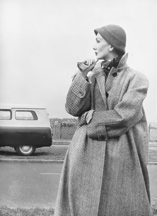 Barbara Goalen in stone-and-white herringbone, single-breasted coat by Aquascutum, 1952.