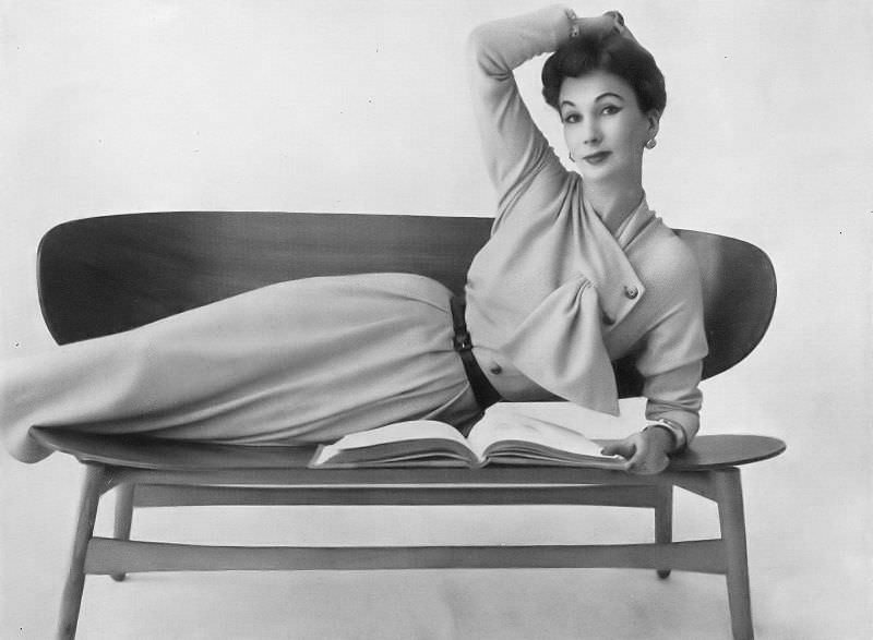 Barbara Goalen in oatmeal wool jersey dress with a side-fastened line by Henry Gowns, 1953.