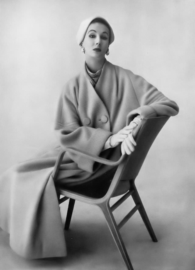 Barbara Goalen in pale apricot fluid velours coat, sleeve sinset with triple stitching by Spectator Sports, felt hat by Lady Vassar, 1953.