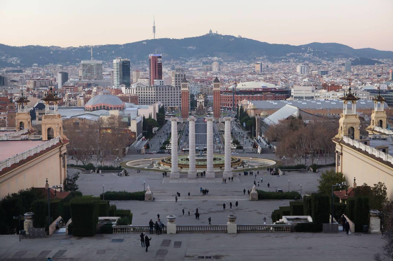 The Four Columns and the Magic Fountain of Montjuïc in Avinguda Maria Cristina, Barcelona, Catalonia, Spain.