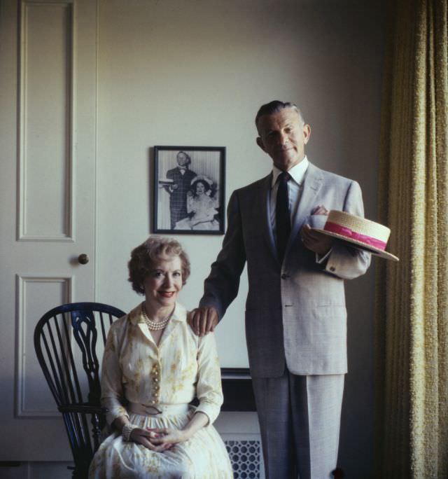 Gracie Allen and George Burns, 1958. On the wall behind them is a photo of the pair, in a similar pose, from their days as vaudeville performers.