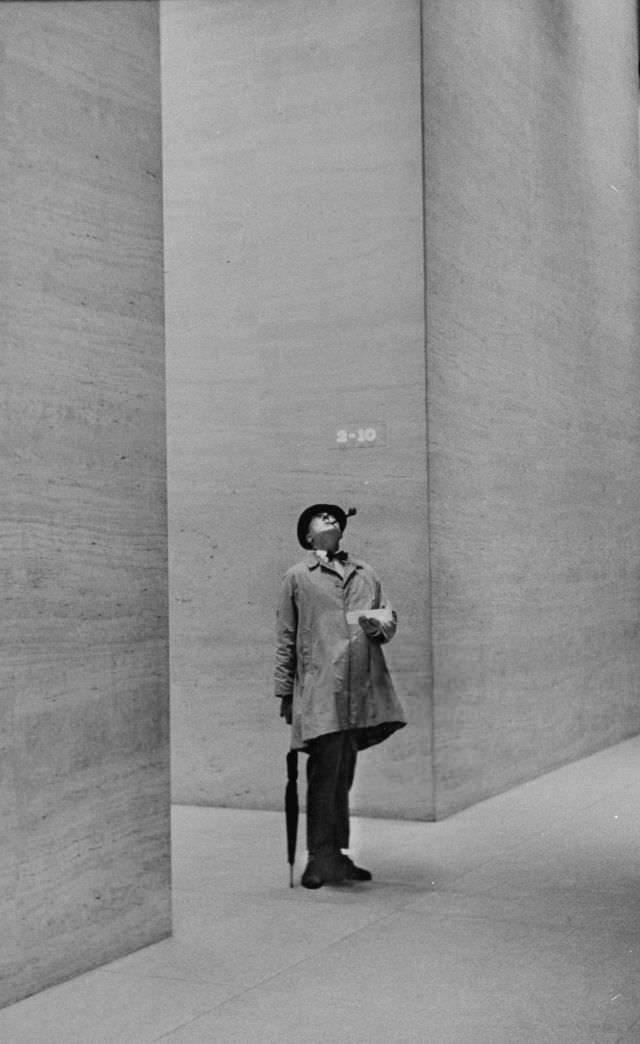 French actor Jacques Tati looked at the high ceiling of a New York City lobby, 1958.