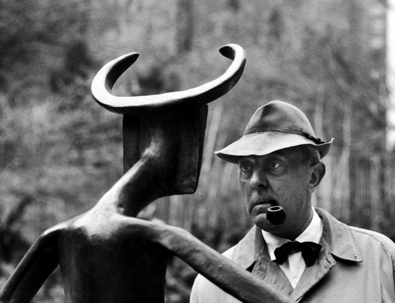 Jacques Tati examined a sculpture by Max Ernst at the Museum of Modern Art, 1958.