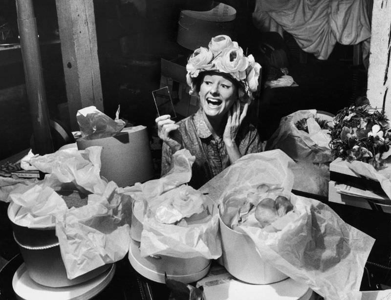 Phyllis Diller sits amid a large collection of hat boxes in the basement of her St. Louis home, 1963.