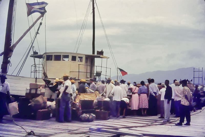 People by the boat with baggage, Cuba, 1950