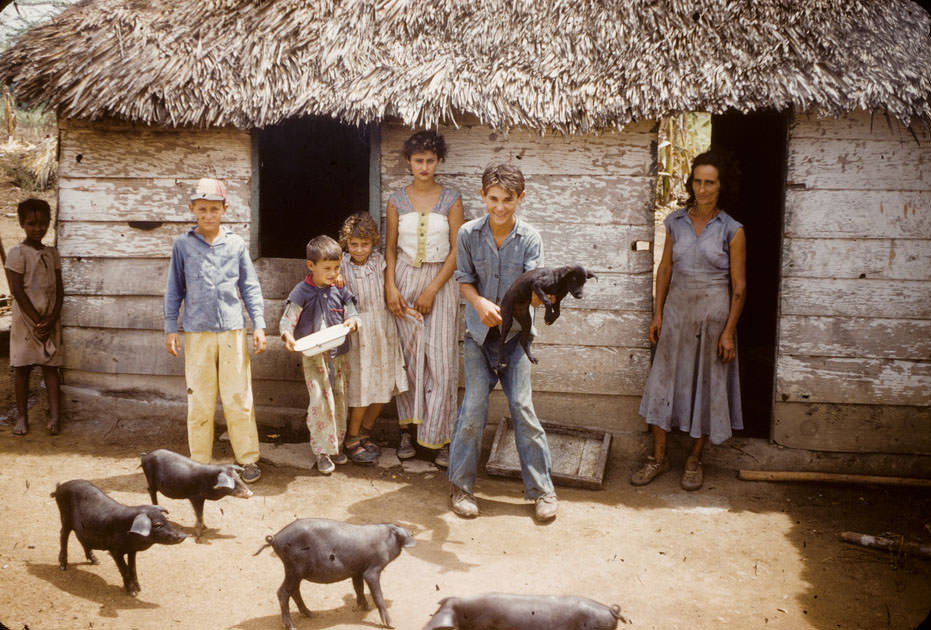 Cuban children stand front of their house