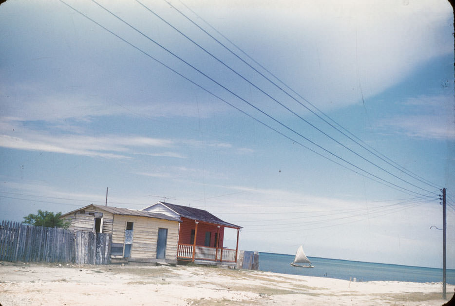 Two houses on ocean front, sailboat in Isabela de Sagua