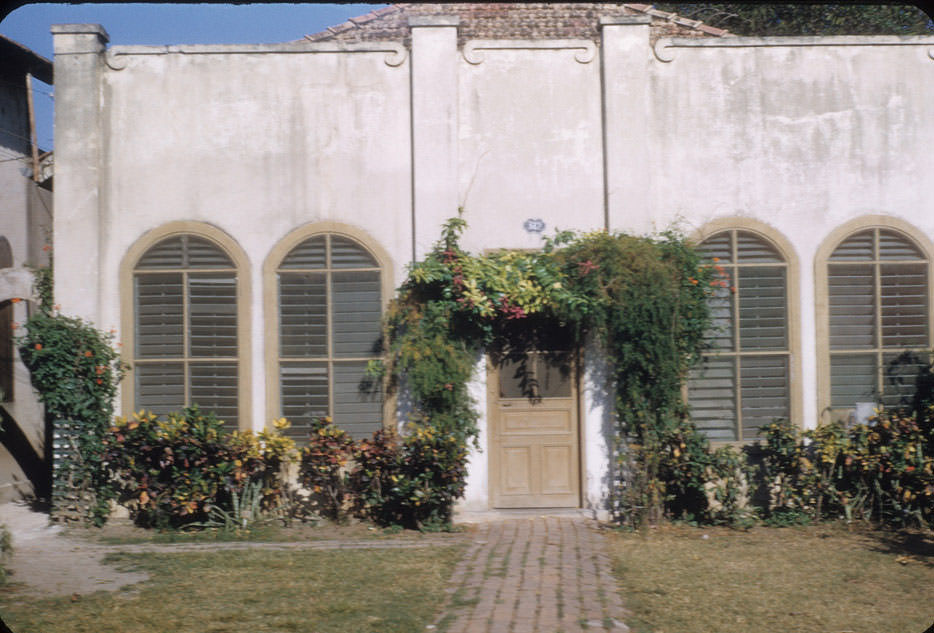 Building with flowers over doorway