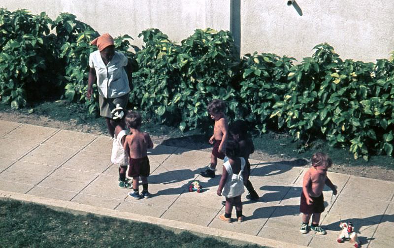 A teacher taking care of children playing with their toys, Cuba, 1976