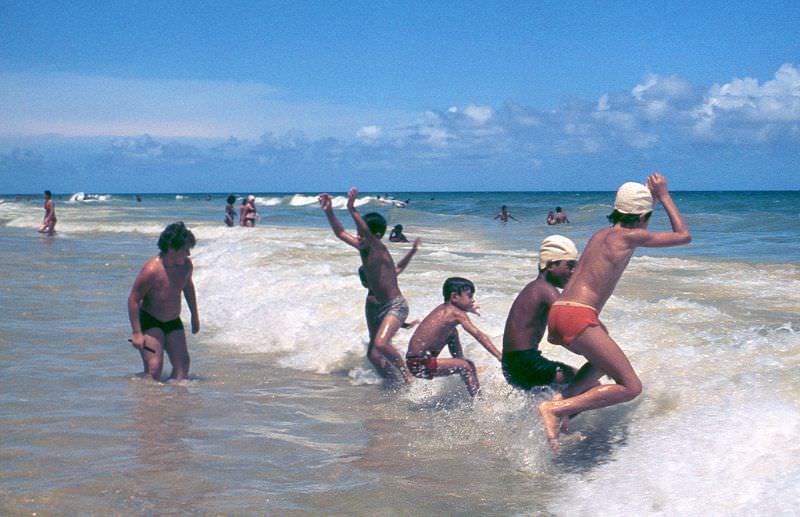 Boys playing in the waves on a beach, Cuba, 1976