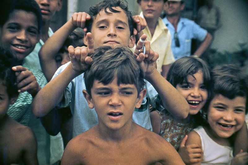 Children having fun in front of the camera, Cuba, 1976