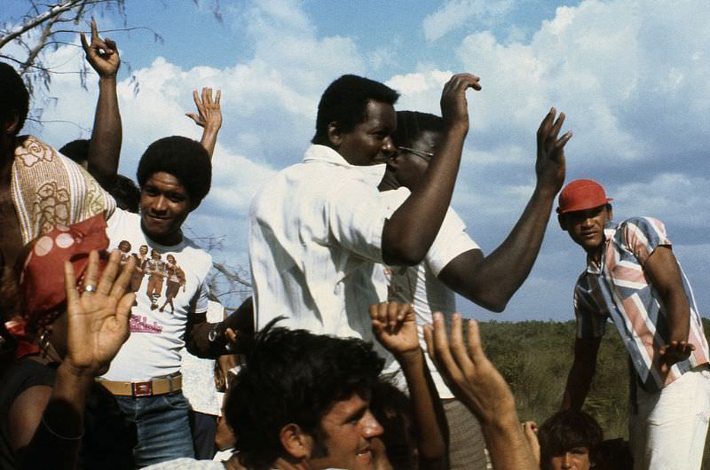 Cuban men waving good-bye, Cuba, 1976
