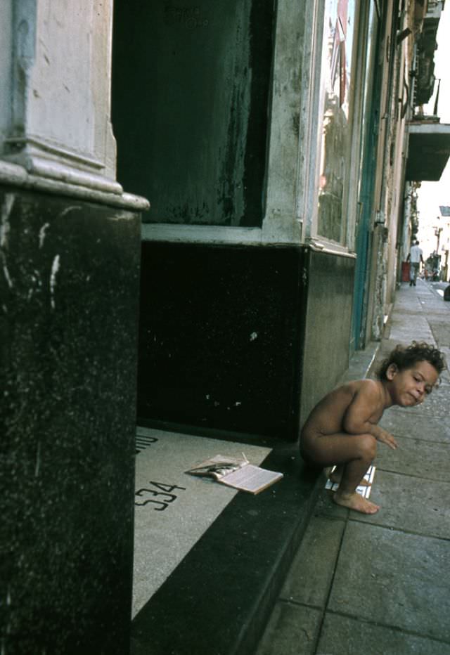 Little girl at the entrance to her home, Cuba, 1976
