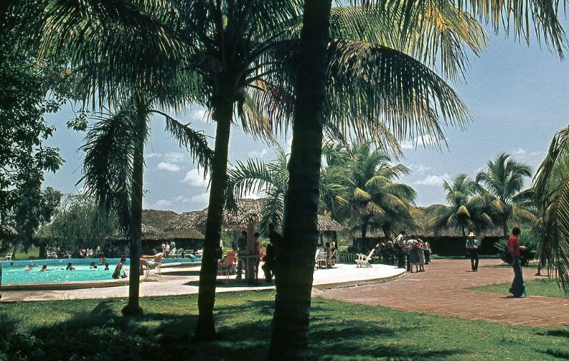 Two buses at avenue with colonial buildings, Matanzas, Cuba, 1976